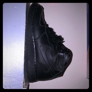 Air Force 1’s all black high top. Kind of beat